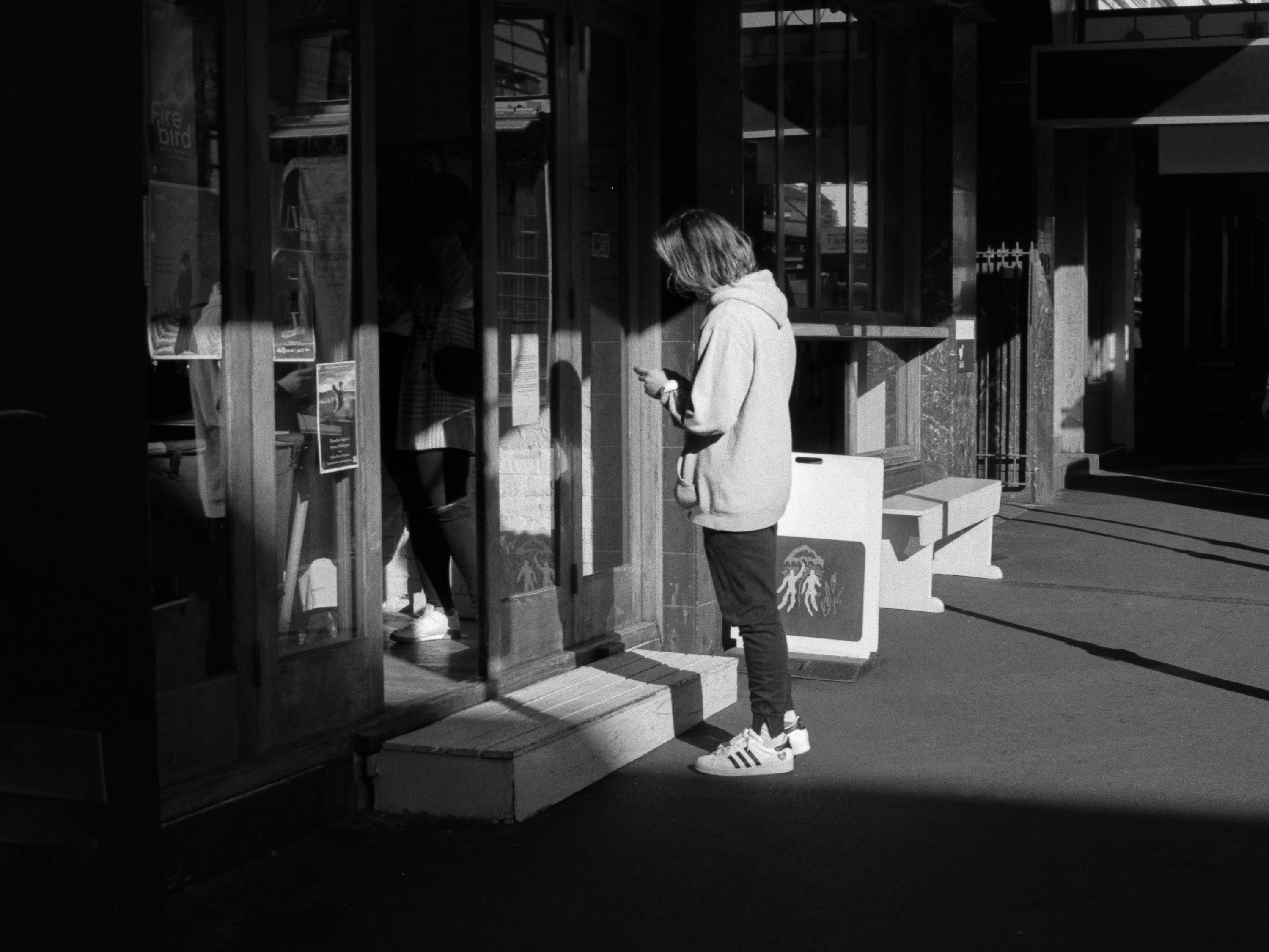 Photo of a person waiting outside a store 