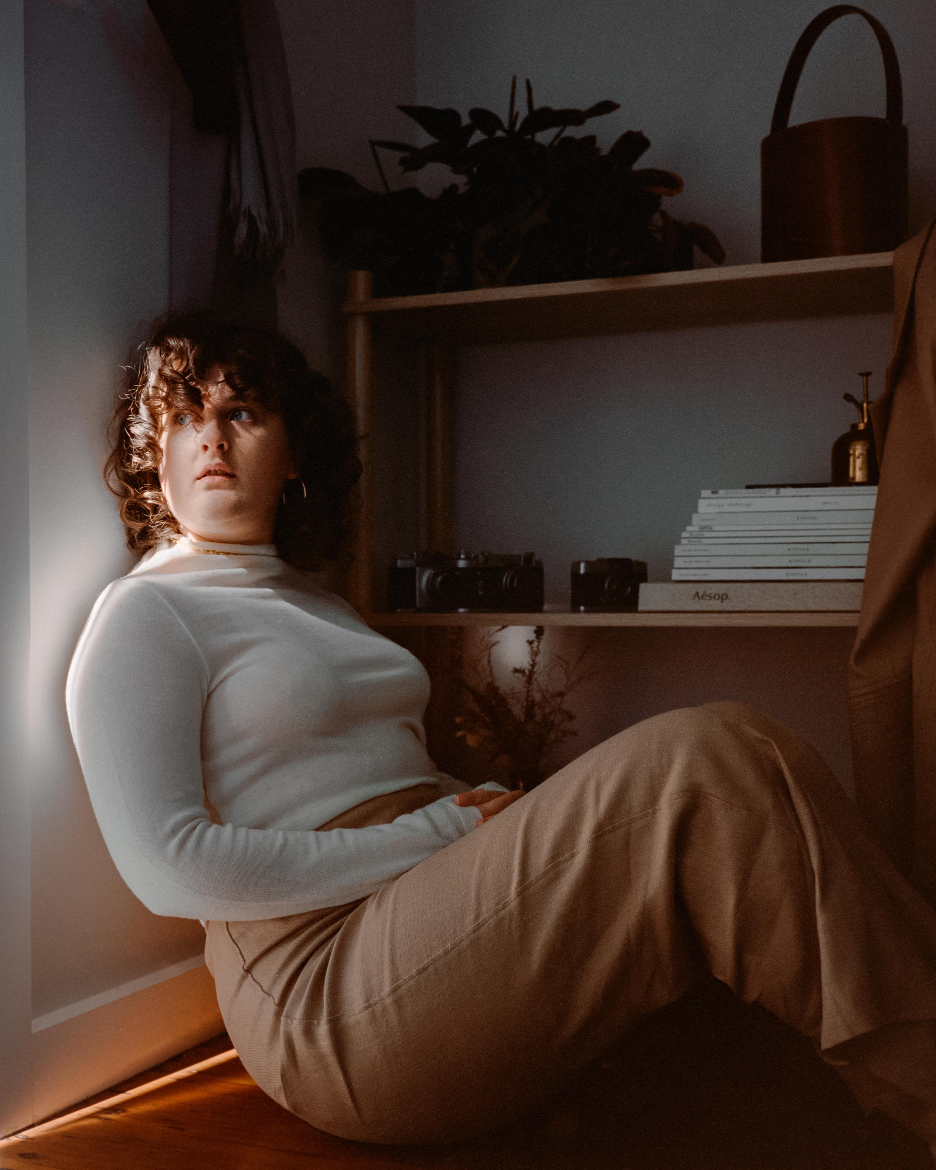 Photo of a woman sitting in a doorway