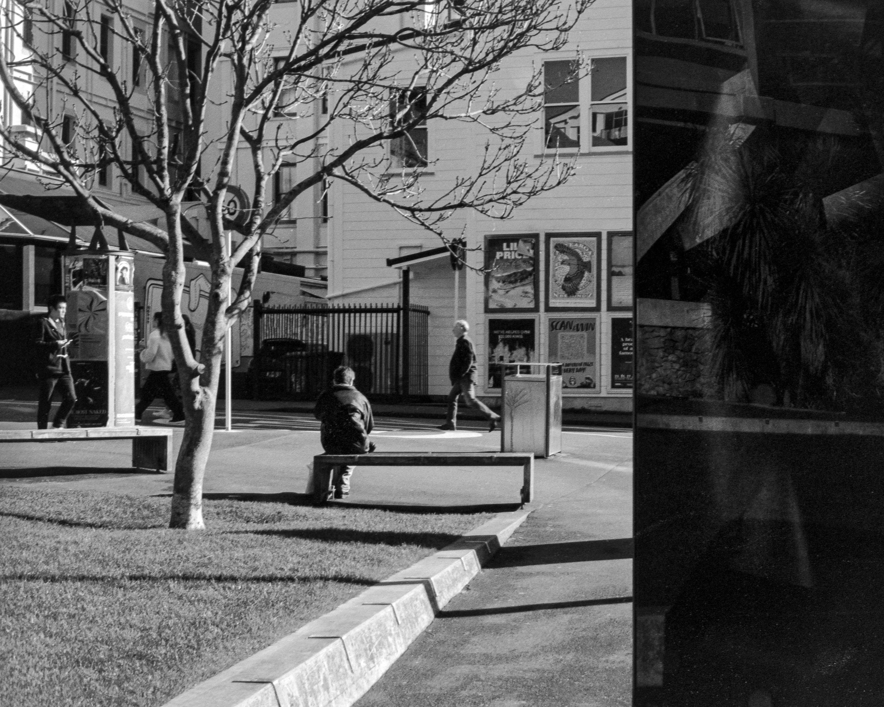Photo of a man sitting alone on a park bench