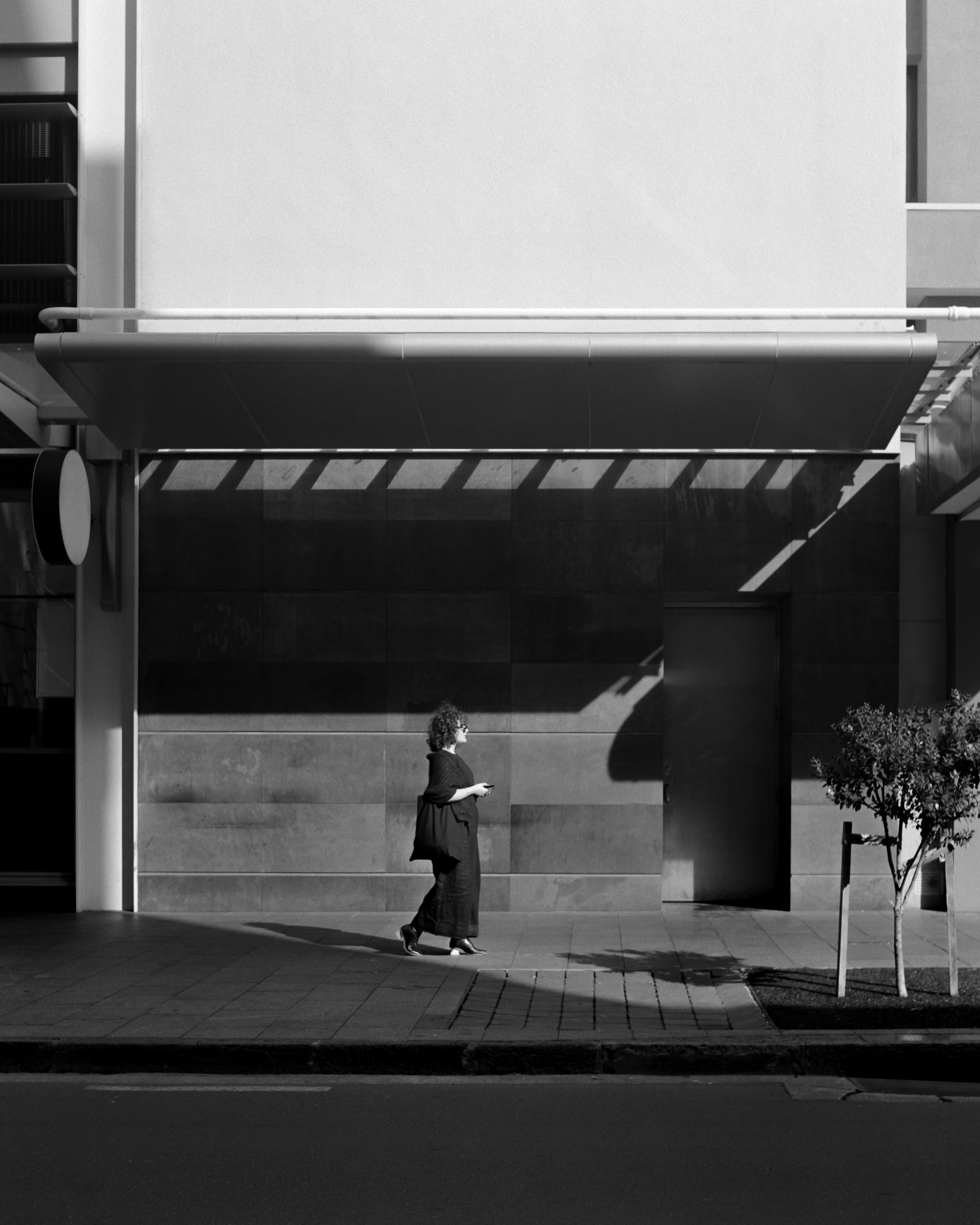 Photo of a woman walking down the street 