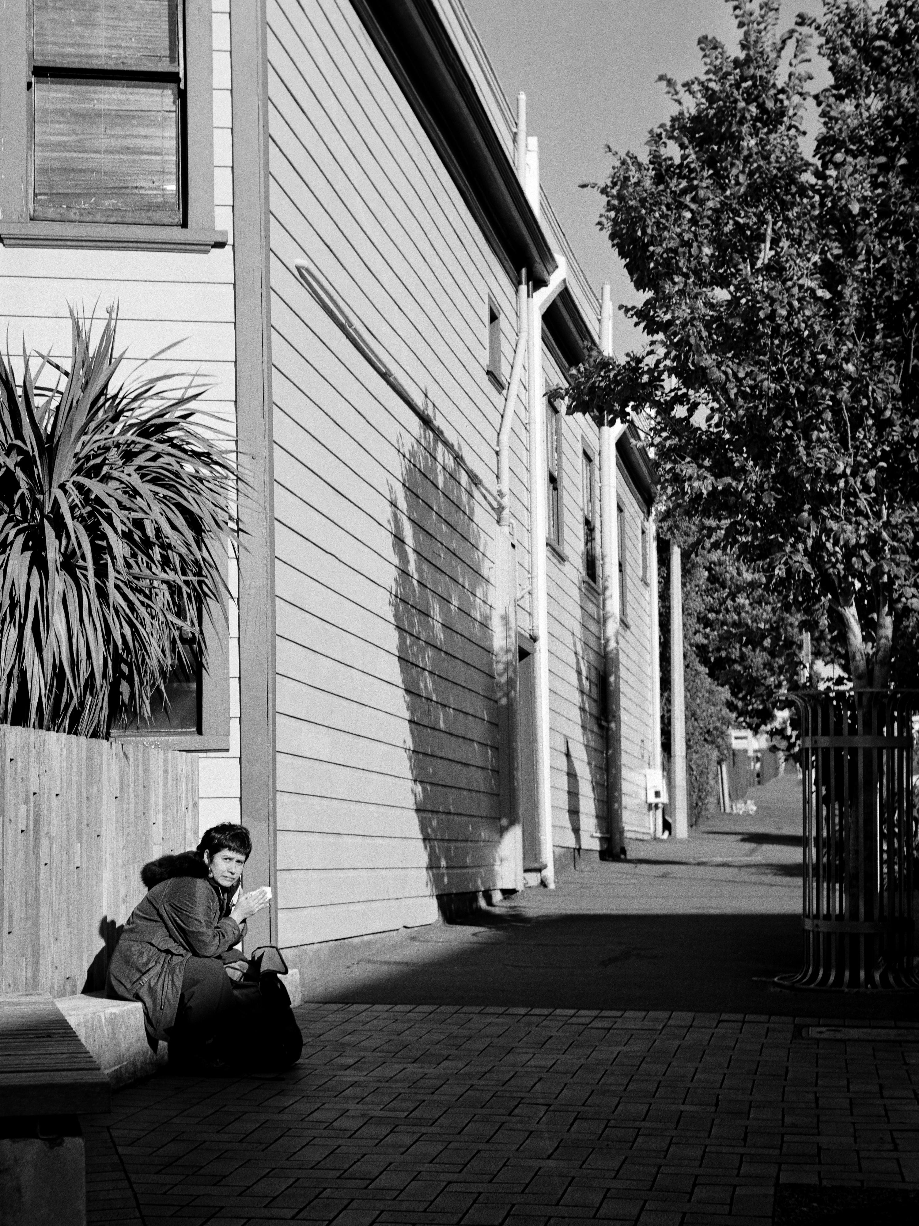 Photo of a woman sitting looking at the photographer 