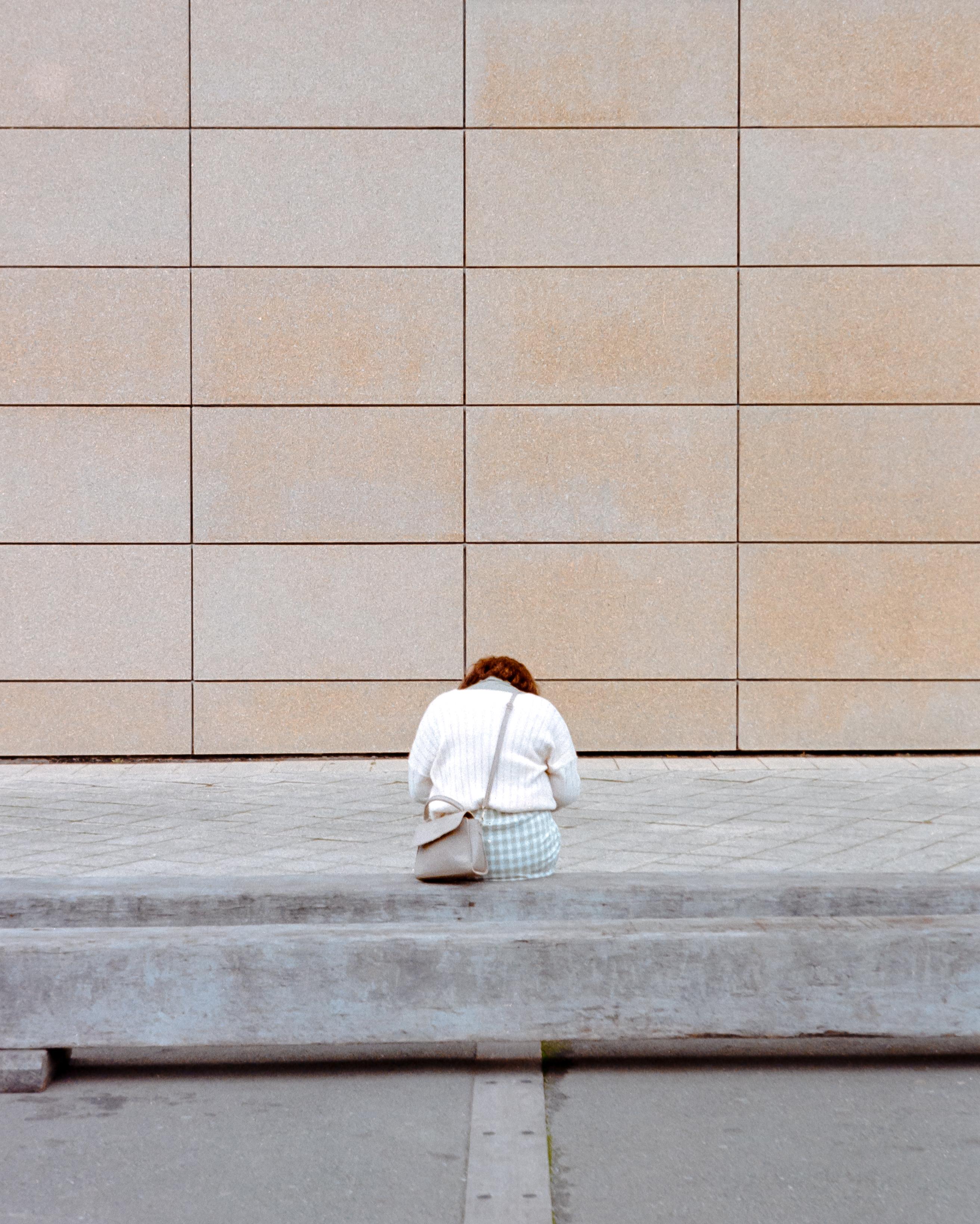 Photo of a woman sitting on a bench 
