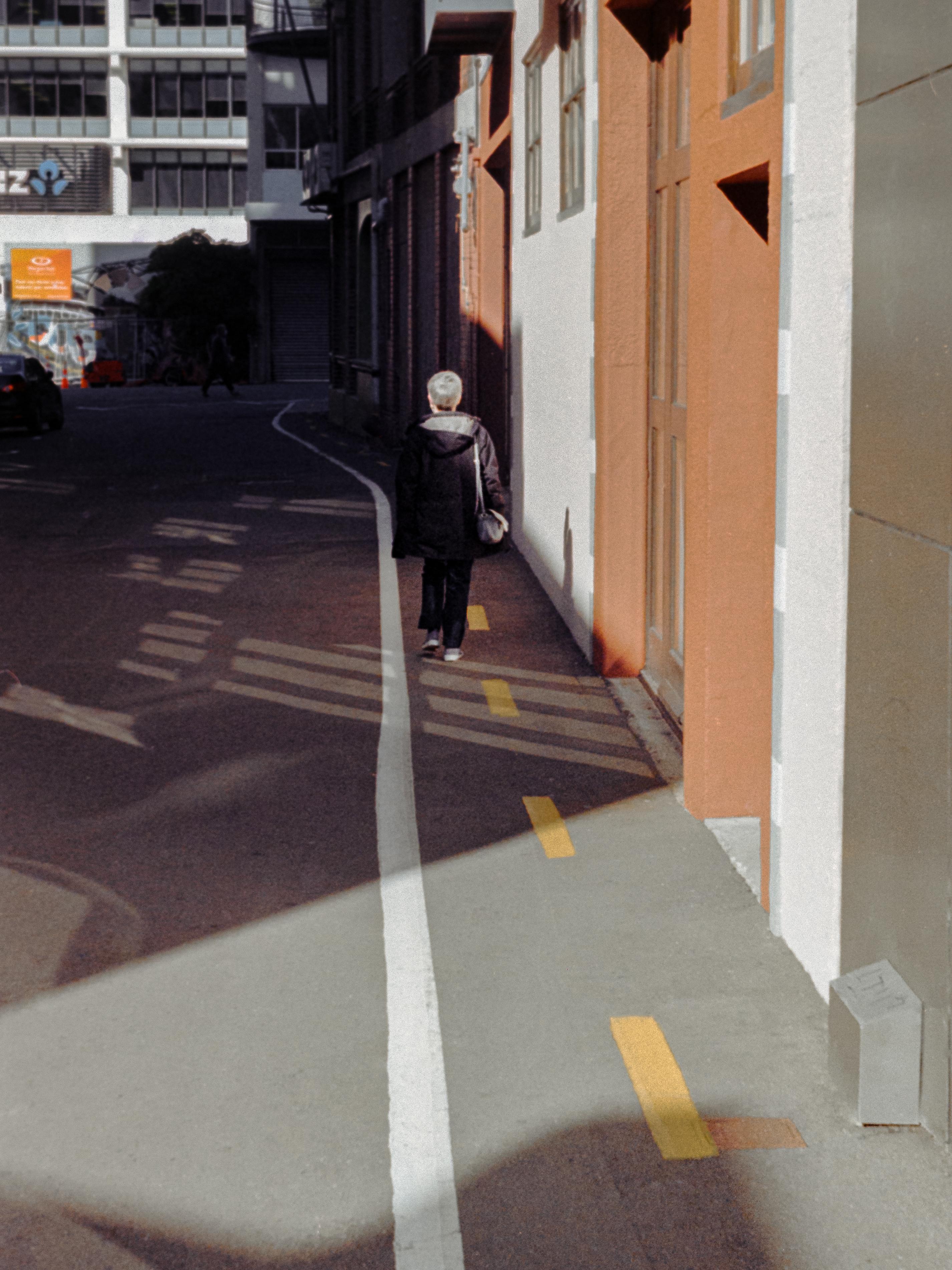 Photo of a woman walking down the street 