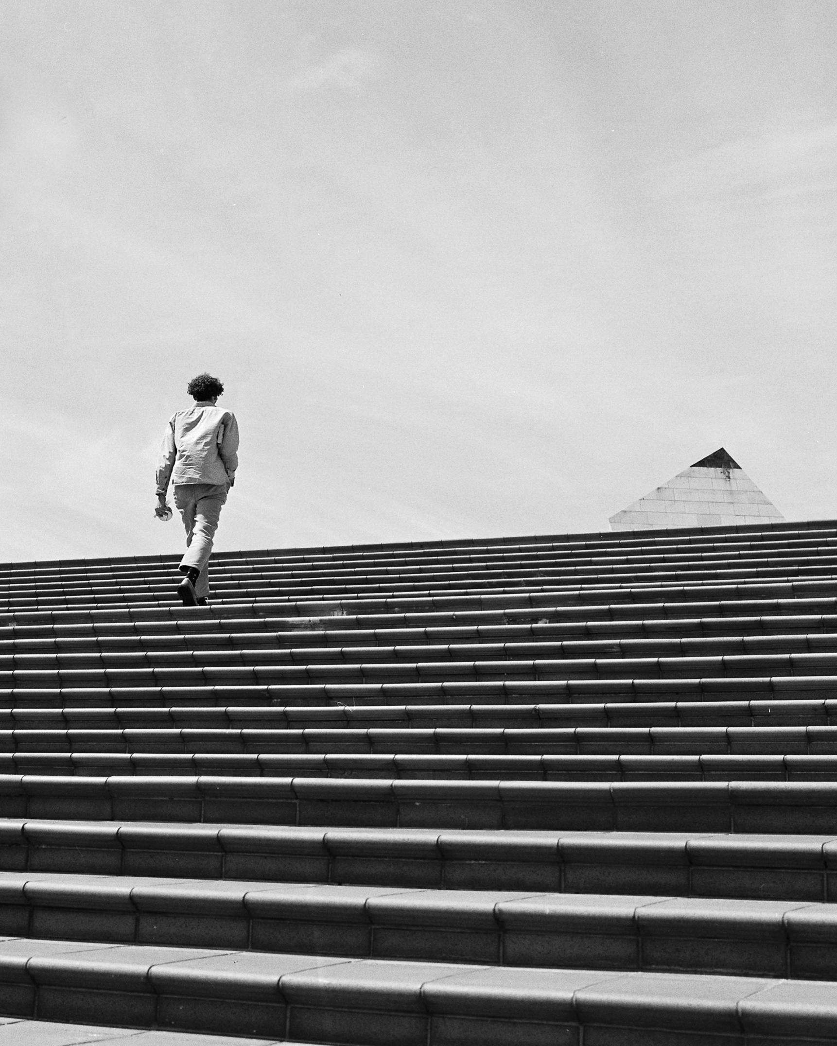 Photo of a man walking up stairs 