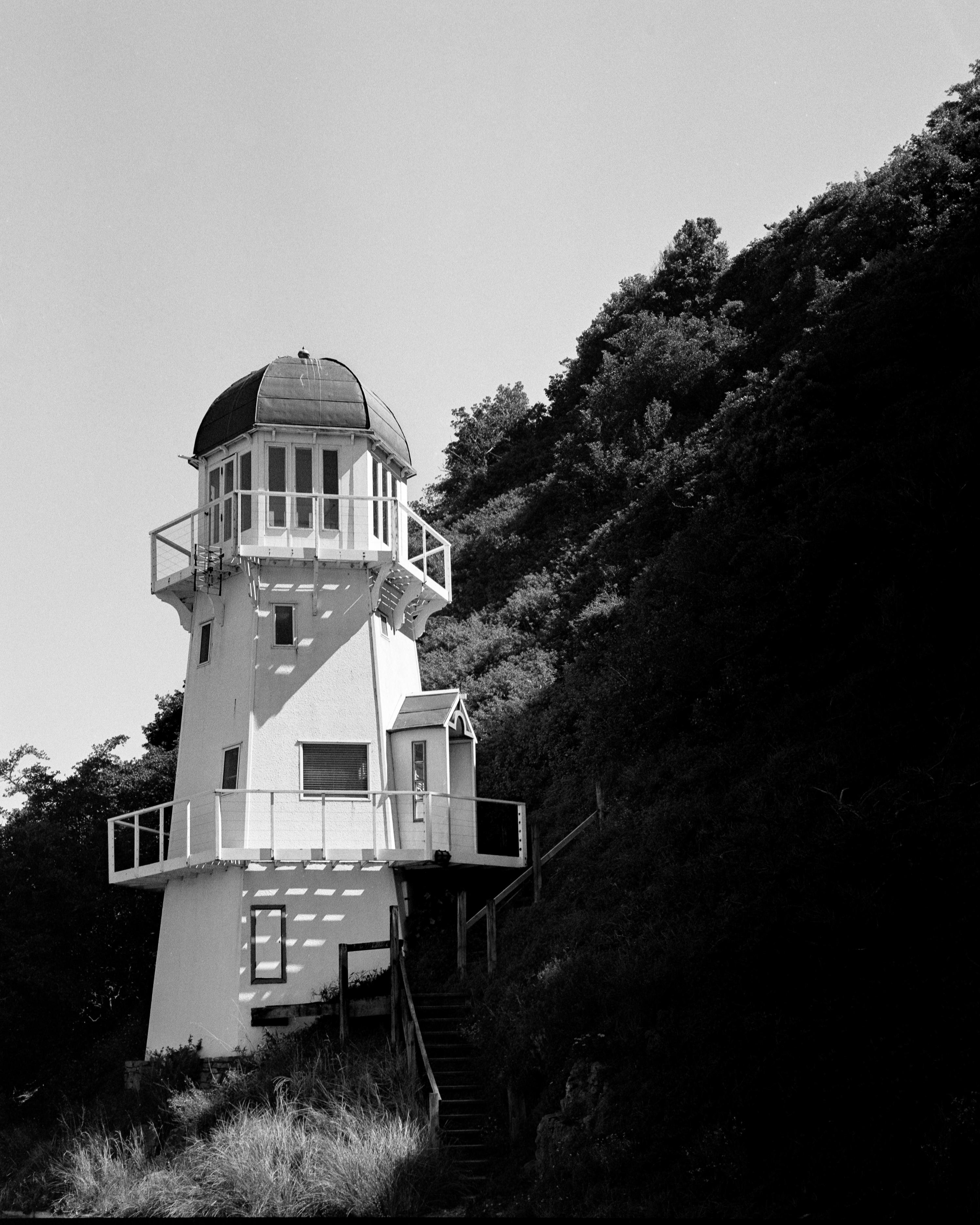Photo of a small lighthouse on a hill 